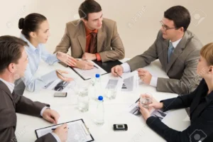 3755505-portrait-of-business-people-sitting-around-table-and-interacting